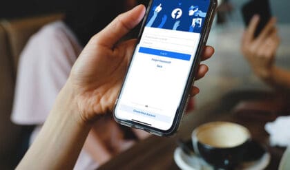 Facebook social media app logo on log-in, sign-up registration page for Facebook stories on mobile app screen on iPhone smart devices in business person's hand at work