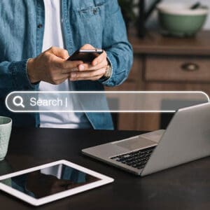 Man using cell phone and notebook to check domain authority